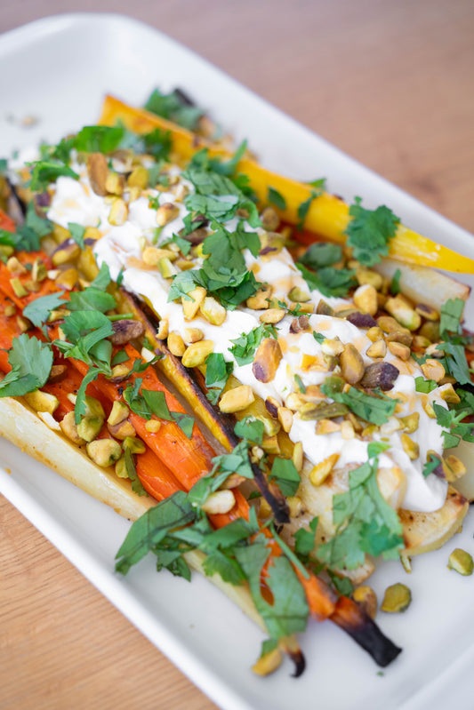 Roasted carrots with Yogurt, Hot Honey, Pistachios, & Fresh Mint and Cilantro